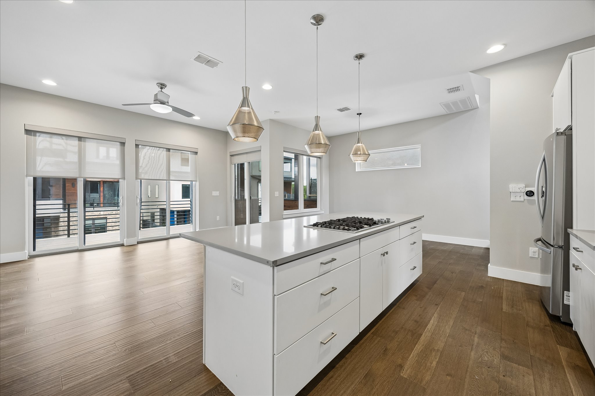 5006 Pecan Springs Road, Unit 6 Austin, TX 78723 - Photo 11 of 30 A contemporary kitchen features a gas cooktop on a large island and ample space for culinary creations.