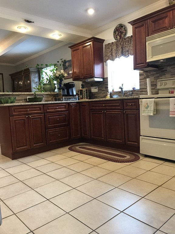 104-106 Milton Street Springfield, MA 01151 - Photo 3 of 17 a kitchen with stainless steel appliances granite countertop a sink stove and cabinets