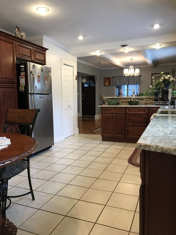 104-106 Milton Street Springfield, MA 01151 - Photo 5 of 17 a kitchen with stainless steel appliances kitchen island granite countertop a refrigerator and a stove