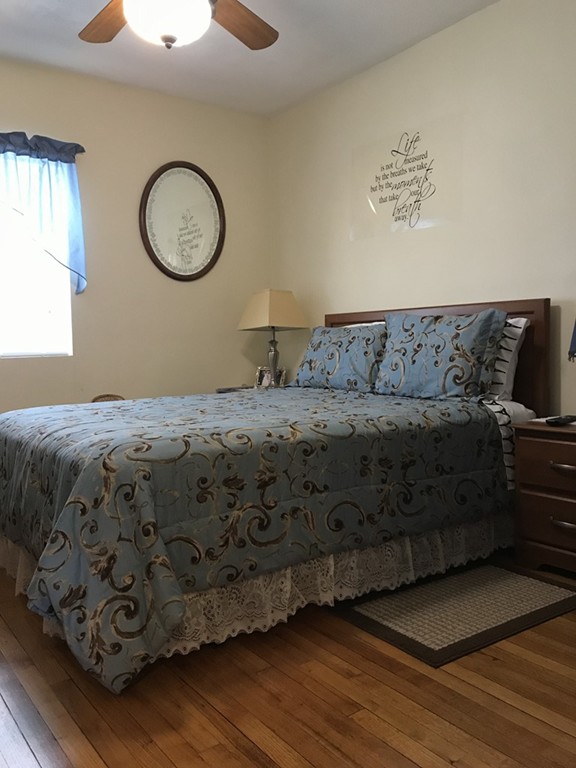 104-106 Milton Street Springfield, MA 01151 - Photo 10 of 17 a bedroom with a bed and cabinets