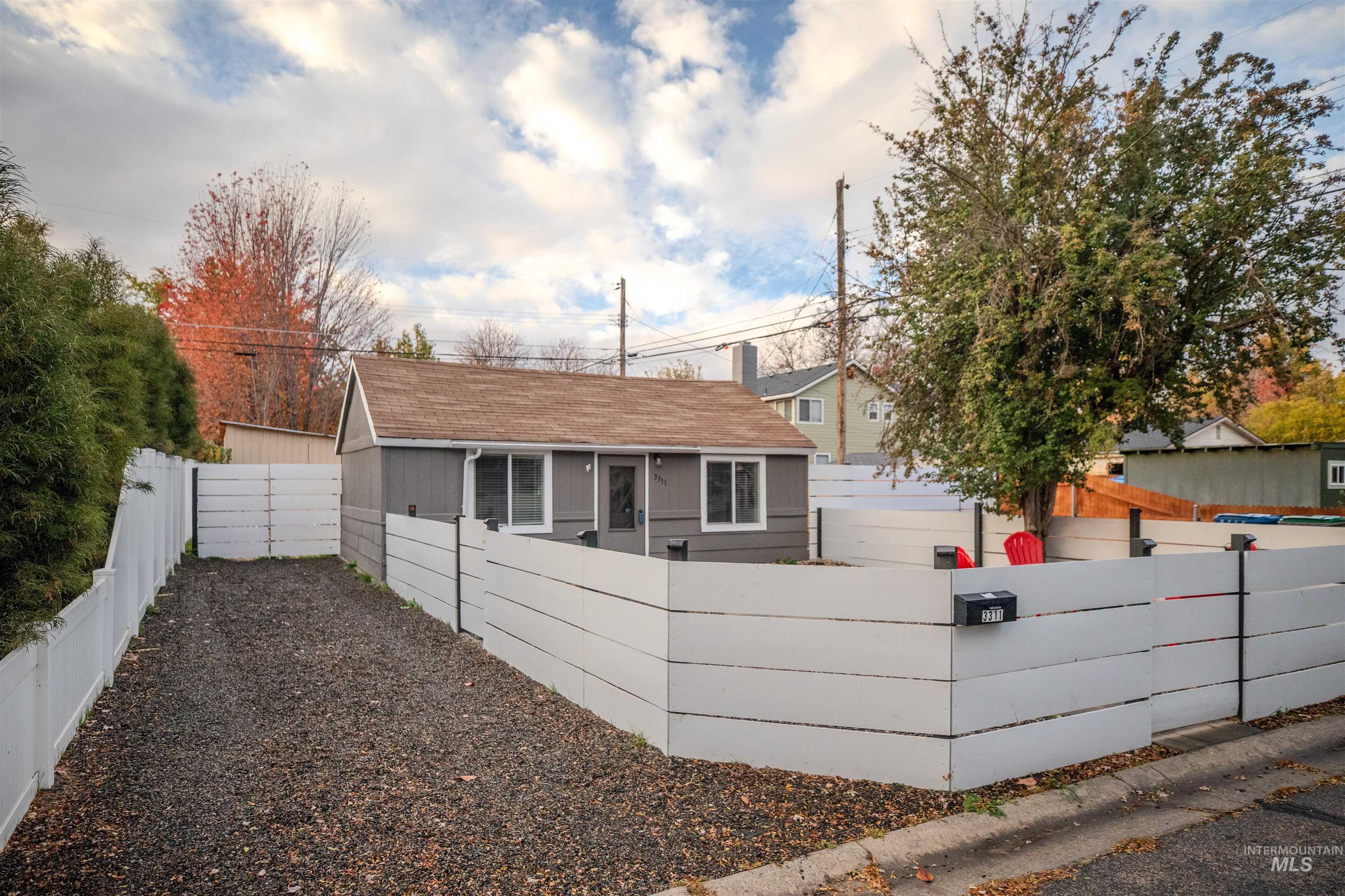3311 West Hamilton Street Boise, ID 83705 - Photo 2 of 32 View of property exterior with a drive way, fenced yard and roof with shingles