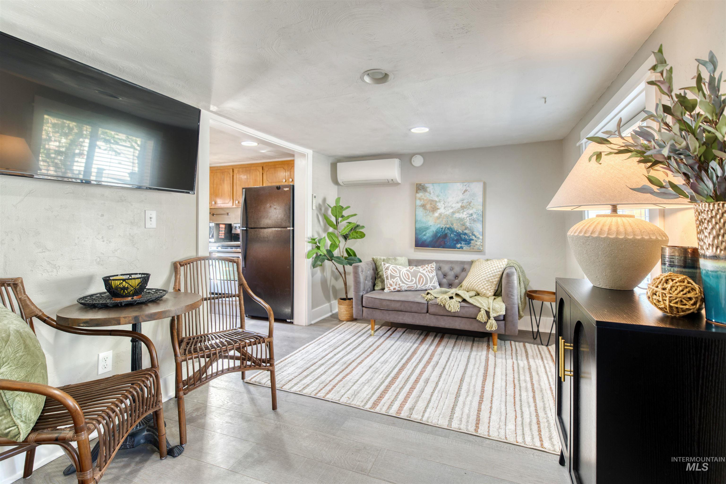 3311 West Hamilton Street Boise, ID 83705 - Photo 9 of 32 Living room featuring a wall mounted AC, recessed lighting, and light wood-style flooring
