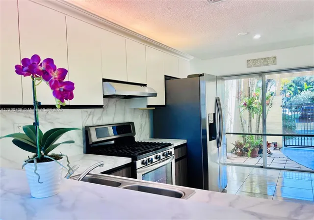 a kitchen with a refrigerator and cabinets