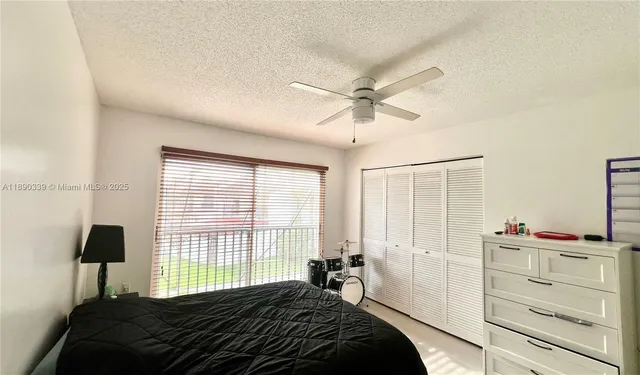a bedroom with a bed a dresser and a window