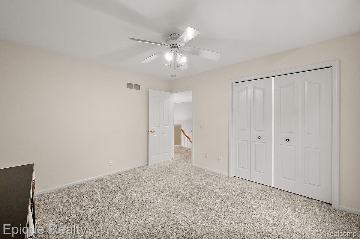 1909 Catlin Drive Rochester, MI 48306 - Photo 39 of 76 Neutral-toned room with light gray carpet flooring