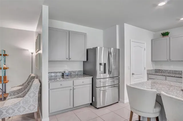 a kitchen with a refrigerator sink and cabinets