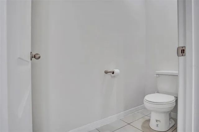 a white toilet sitting next to a shower