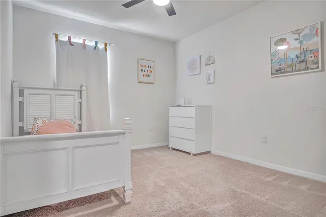 a bedroom with a bed a desk and chair