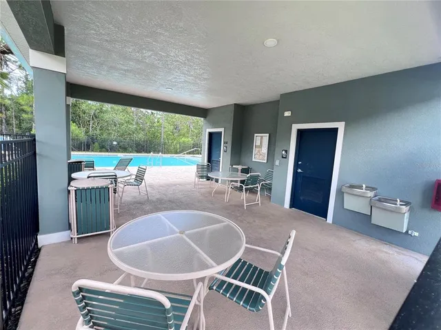 a view of a swimming pool with a patio