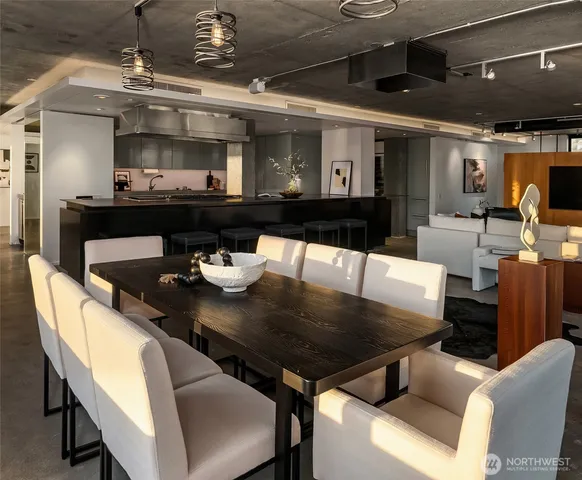 a view of a dining room with furniture and a chandelier