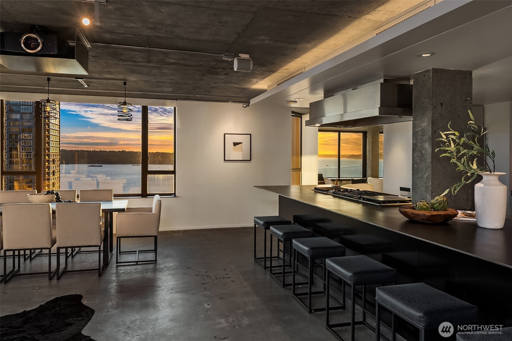 2201 3rd Avenue, Unit 2601 Seattle, WA 98121 - Photo 2 of 40 a room with wooden floor table and chairs