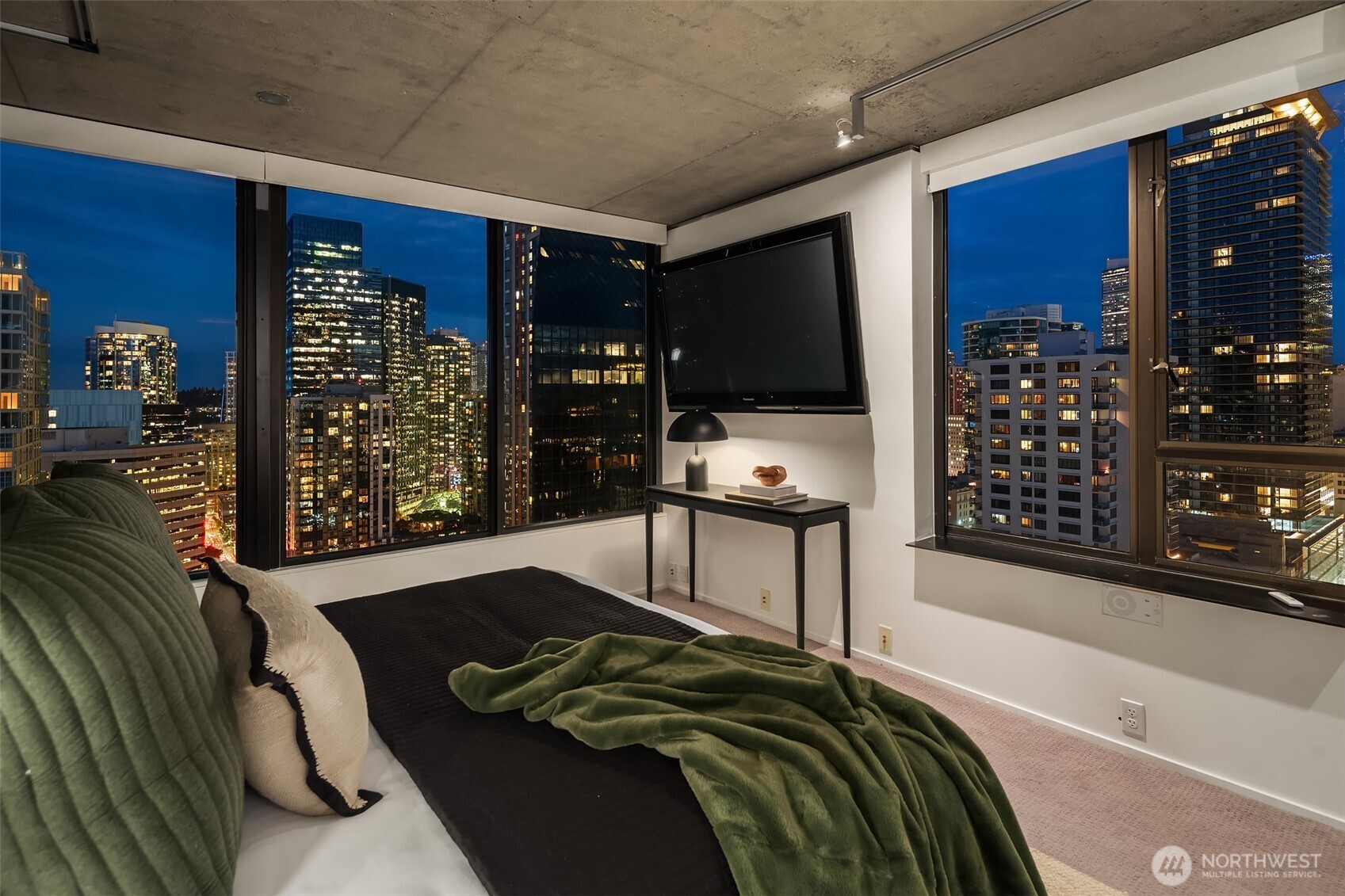 2201 3rd Avenue, Unit 2601 Seattle, WA 98121 - Photo 23 of 40 a bedroom with a bed and a flat tv screen