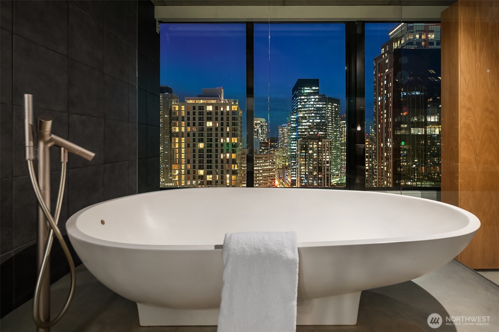 2201 3rd Avenue, Unit 2601 Seattle, WA 98121 - Photo 24 of 40 a white bath tub sitting in a bathroom