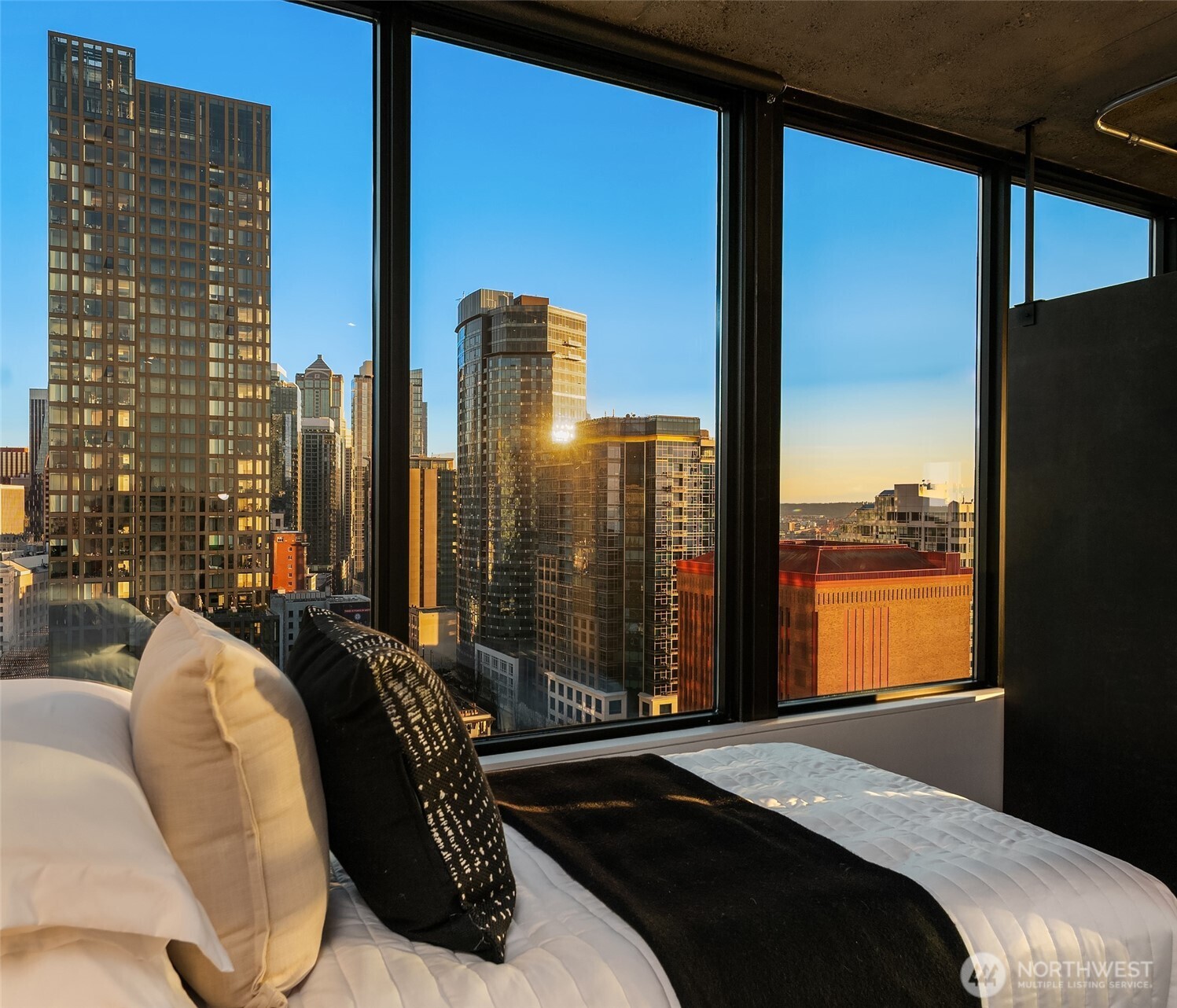 2201 3rd Avenue, Unit 2601 Seattle, WA 98121 - Photo 28 of 40 a bedroom with bed and glass windows