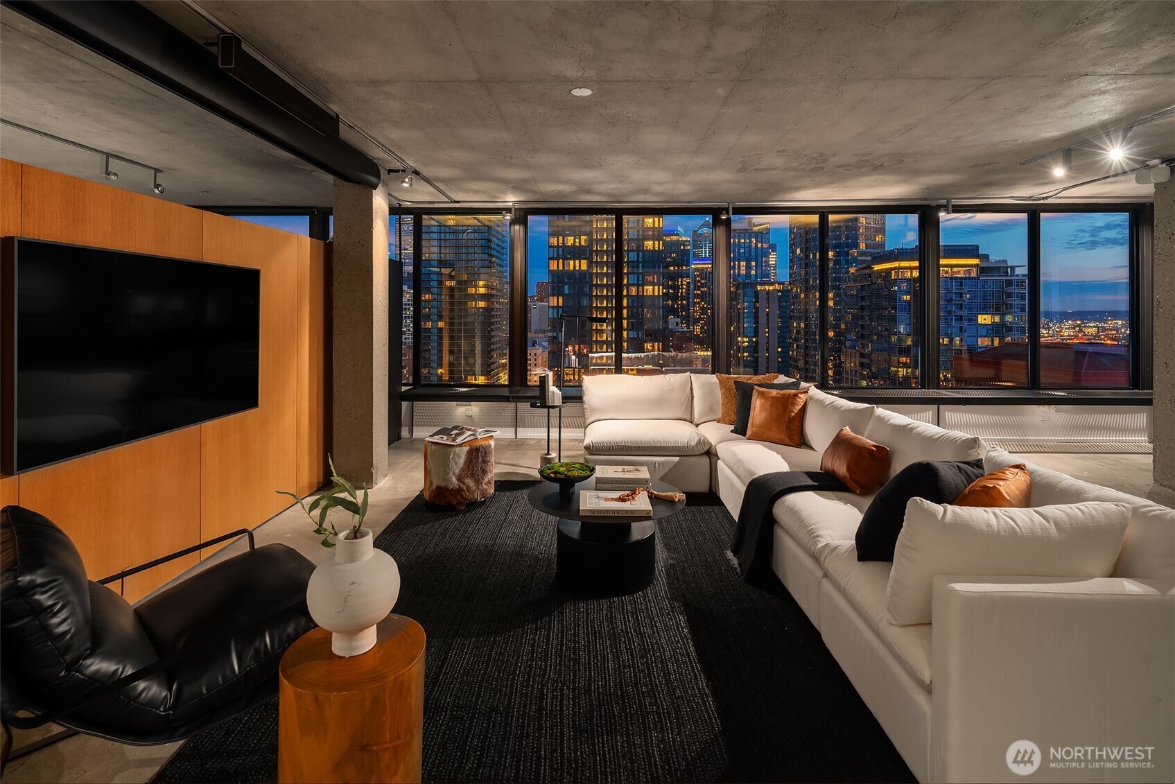 2201 3rd Avenue, Unit 2601 Seattle, WA 98121 - Photo 3 of 40 a living room with furniture a flat screen tv and a floor to ceiling window