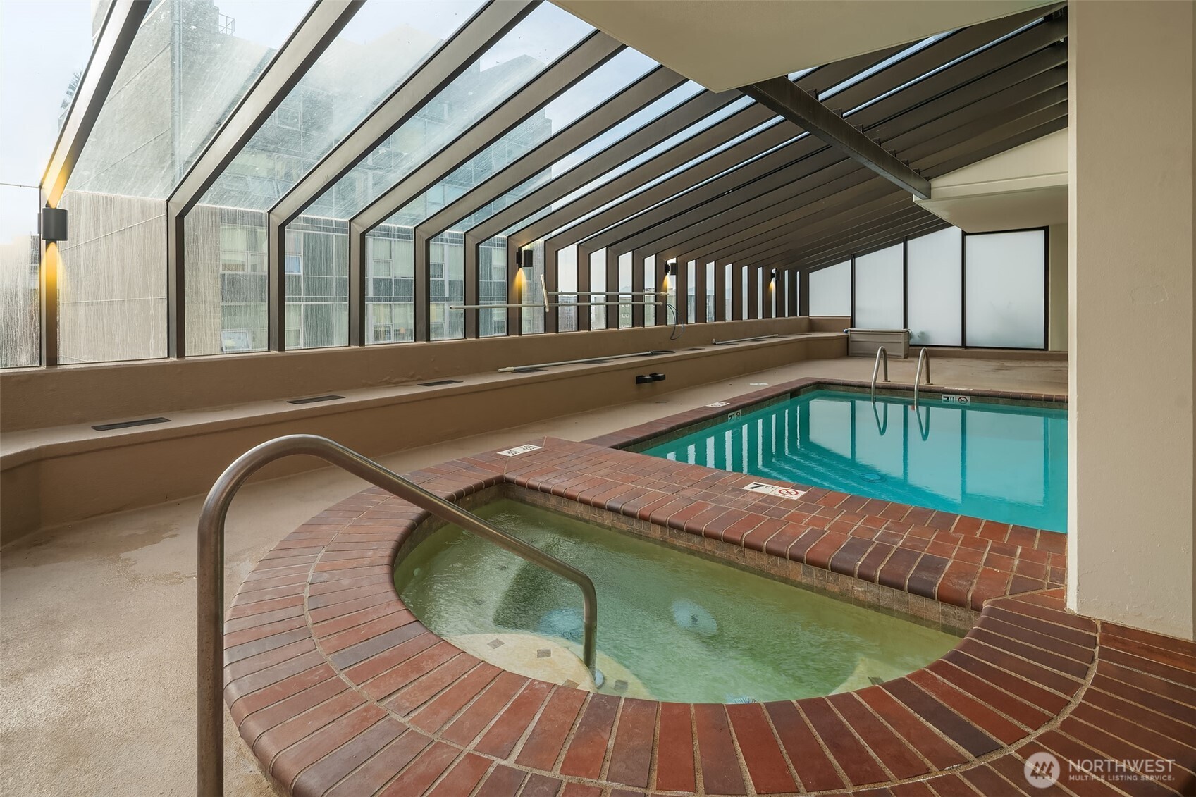 2201 3rd Avenue, Unit 2601 Seattle, WA 98121 - Photo 36 of 40 a view of a swimming pool with a lounge chairs