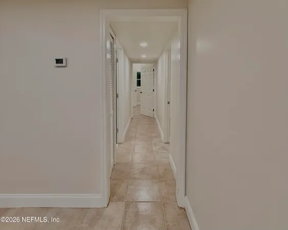 a view of a hallway with wooden shelves