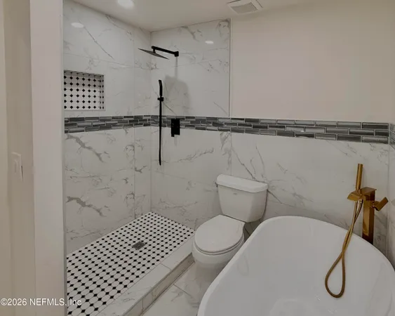 a bathroom with a sink mirror vanity and toilet