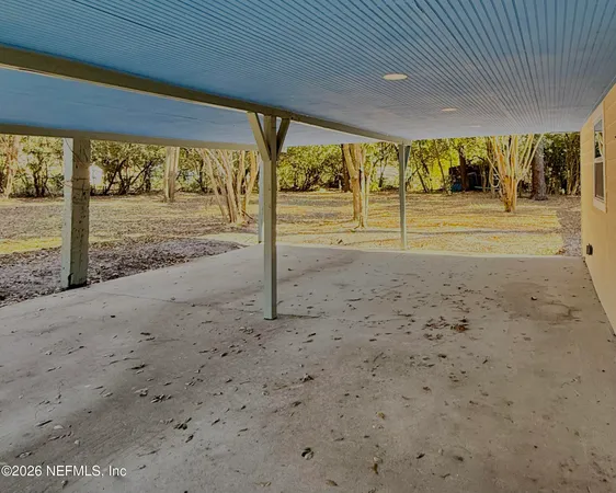 a view of a field with trees