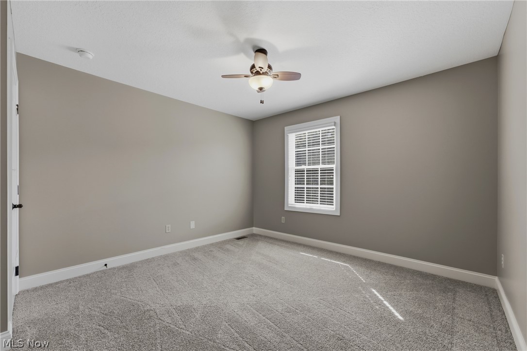 3955 Spring Brook Way Wooster, OH 44691 - Photo 26 of 50 Carpeted flooring, neutral wall tones, ceiling fan with integrated lighting, and a window with blinds