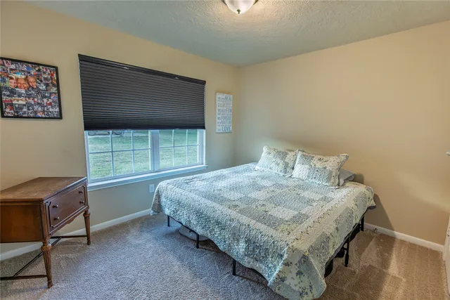 a view of swimming pool with lawn chairs and wooden fence