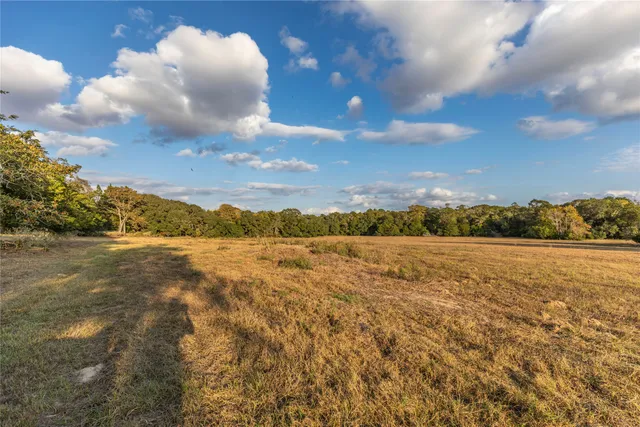 an aerial view of a house with a yard and garden