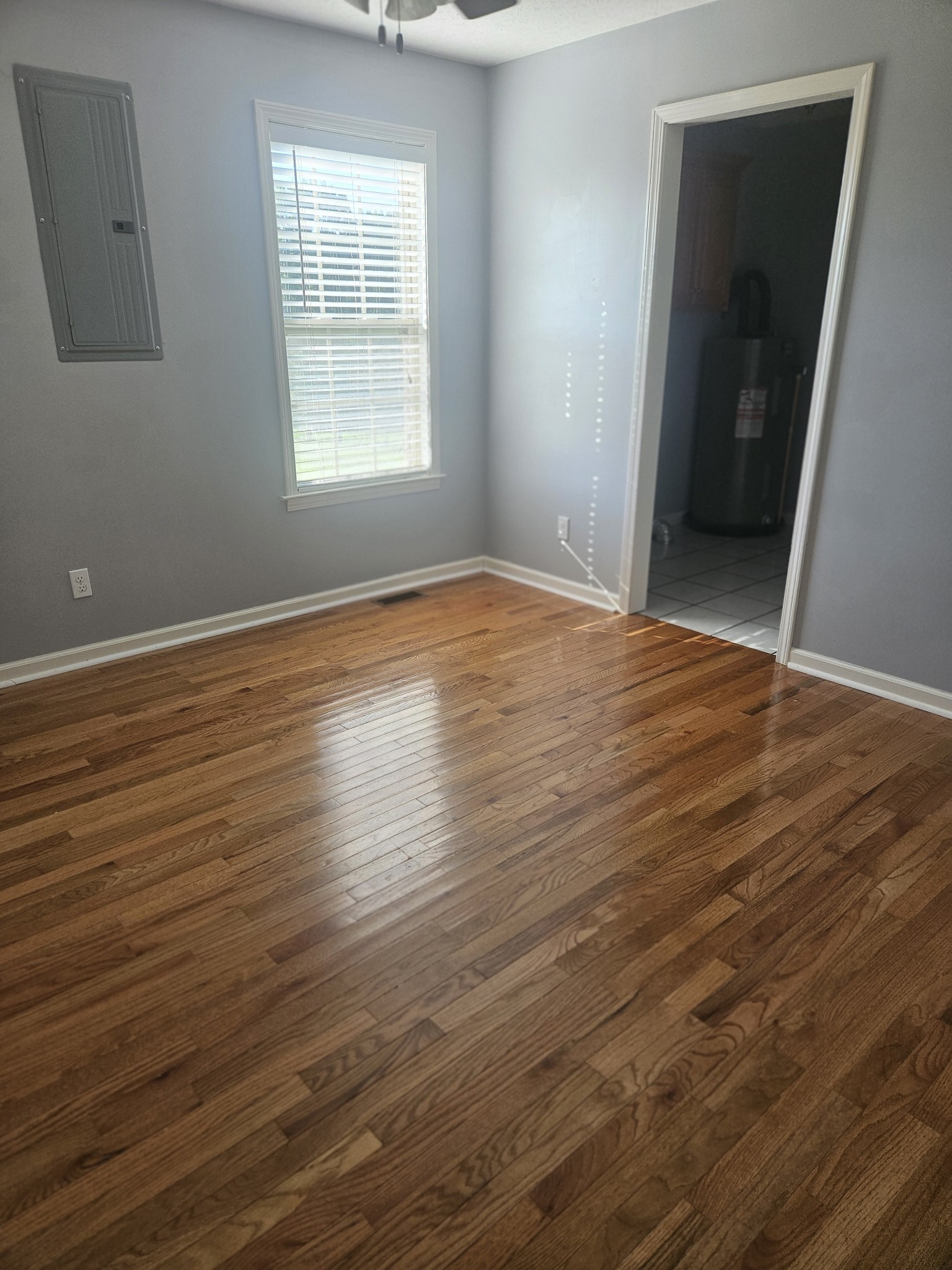 412 Hawkins Road Westmoreland, TN 37186 - Photo 14 of 20 an empty room with wooden floor and windows