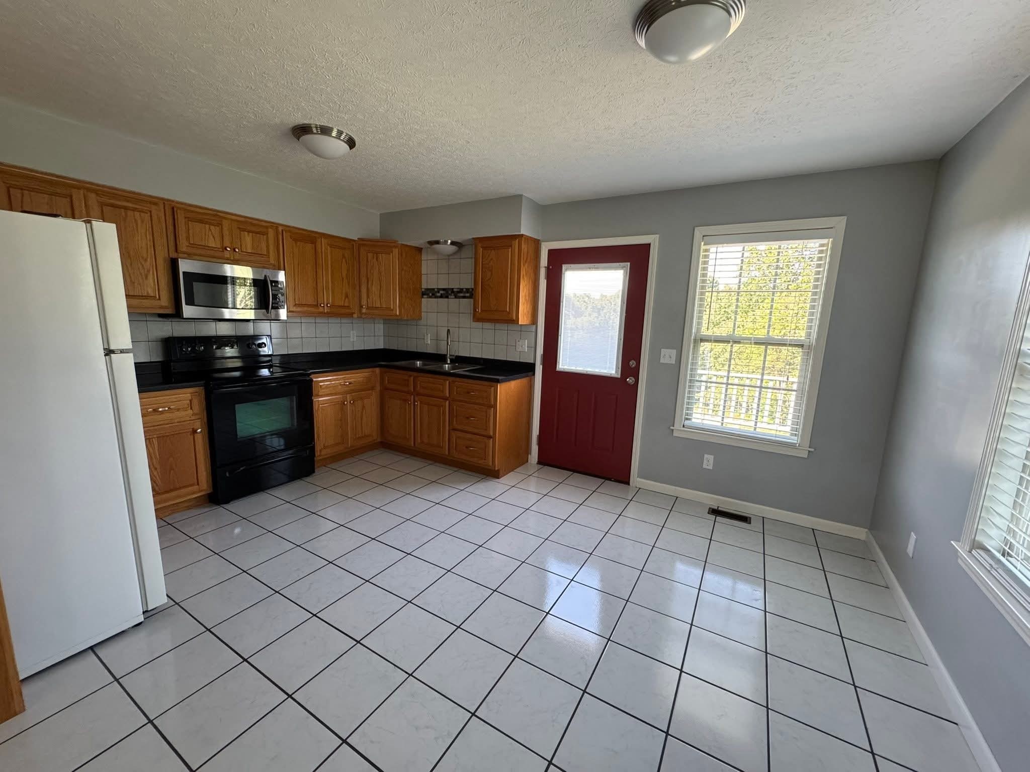 412 Hawkins Road Westmoreland, TN 37186 - Photo 16 of 20 a kitchen with stainless steel appliances granite countertop a refrigerator and a sink