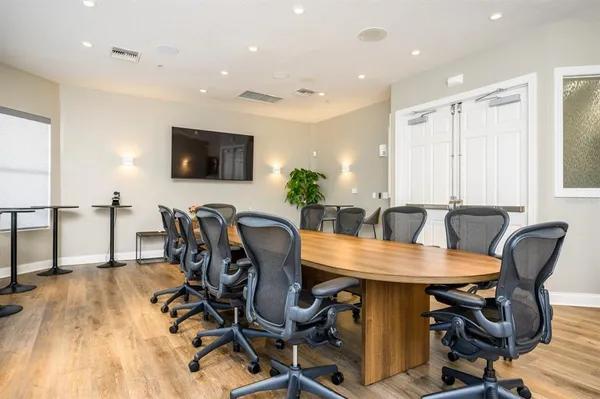 a view of a dining room with furniture and a flat screen tv