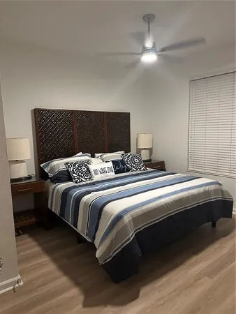 a bedroom with bed and a chandelier