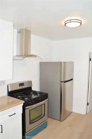 a kitchen with a stove and a refrigerator