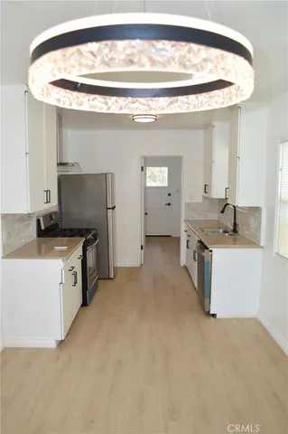 a kitchen with stainless steel appliances granite countertop a sink and cabinets