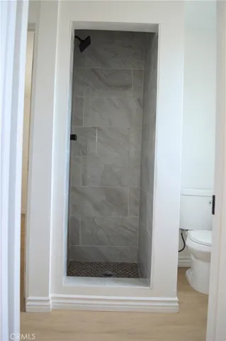 a bathroom with a toilet and a shower