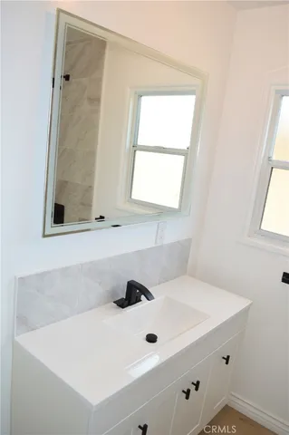 a bathroom with a sink and a window