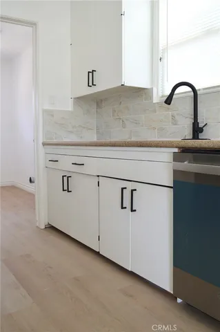 a close view of a sink a faucet and appliance in the kitchen