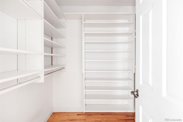 a view of a walk in closet with empty racks