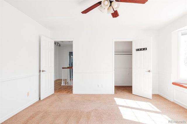 a view of a room that has a bed and a cabinet