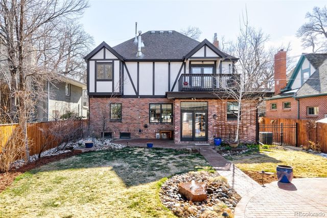 a front view of a house with a yard outdoor seating and covered with water fall