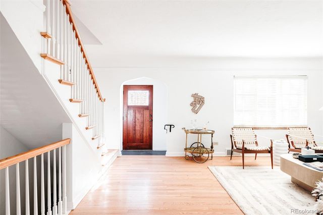 a view of a livingroom with wooden floor and furniture