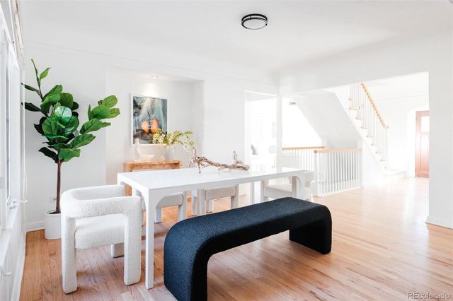 a bedroom with a bed potted plant on the counter and a large window