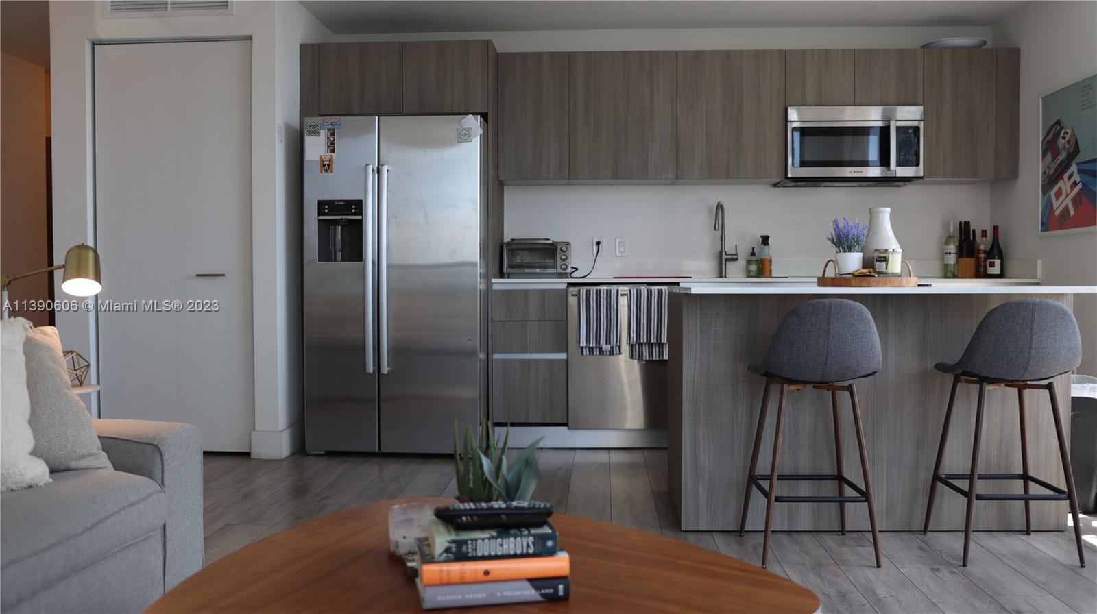 a kitchen with stainless steel appliances a refrigerator and a stove top oven
