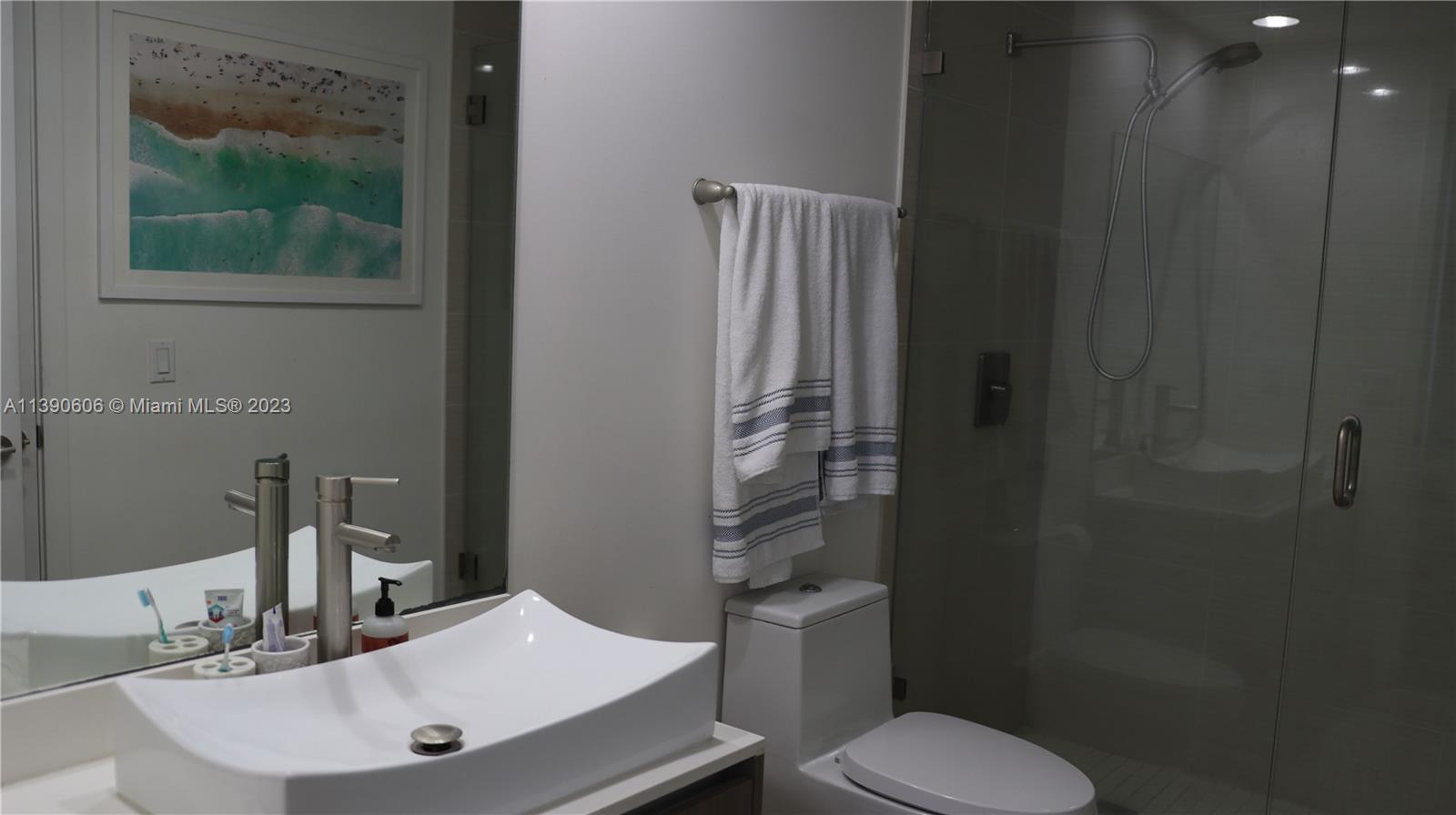 201 Southwest 17th Road, Unit 606 Miami, FL 33129 - Photo 13 of 37 a bathroom with a sink toilet and mirror