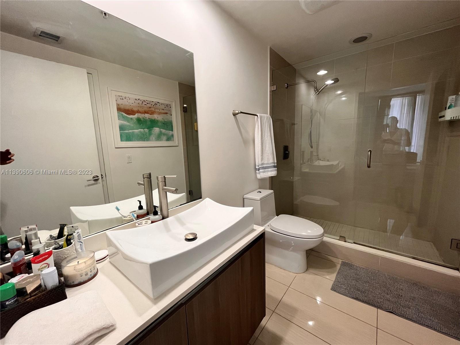 201 Southwest 17th Road, Unit 606 Miami, FL 33129 - Photo 14 of 37 a bathroom with a sink mirror and toilet