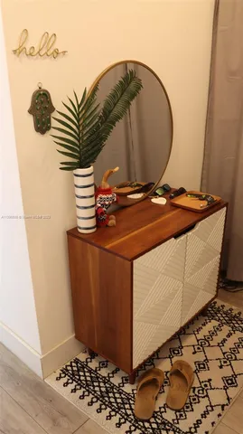 a room with a wooden floor and a potted plant