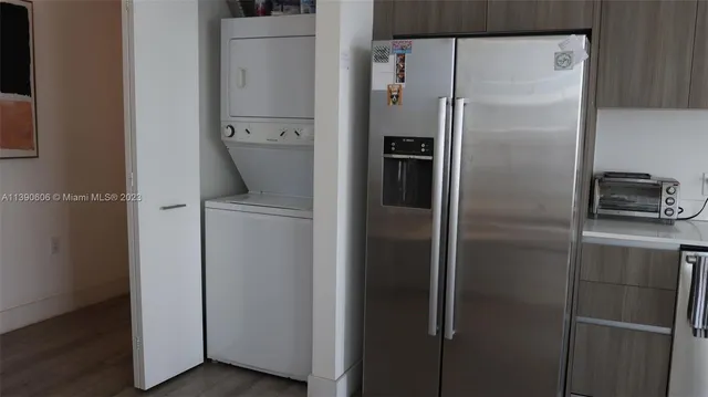 a metallic refrigerator freezer sitting in a kitchen