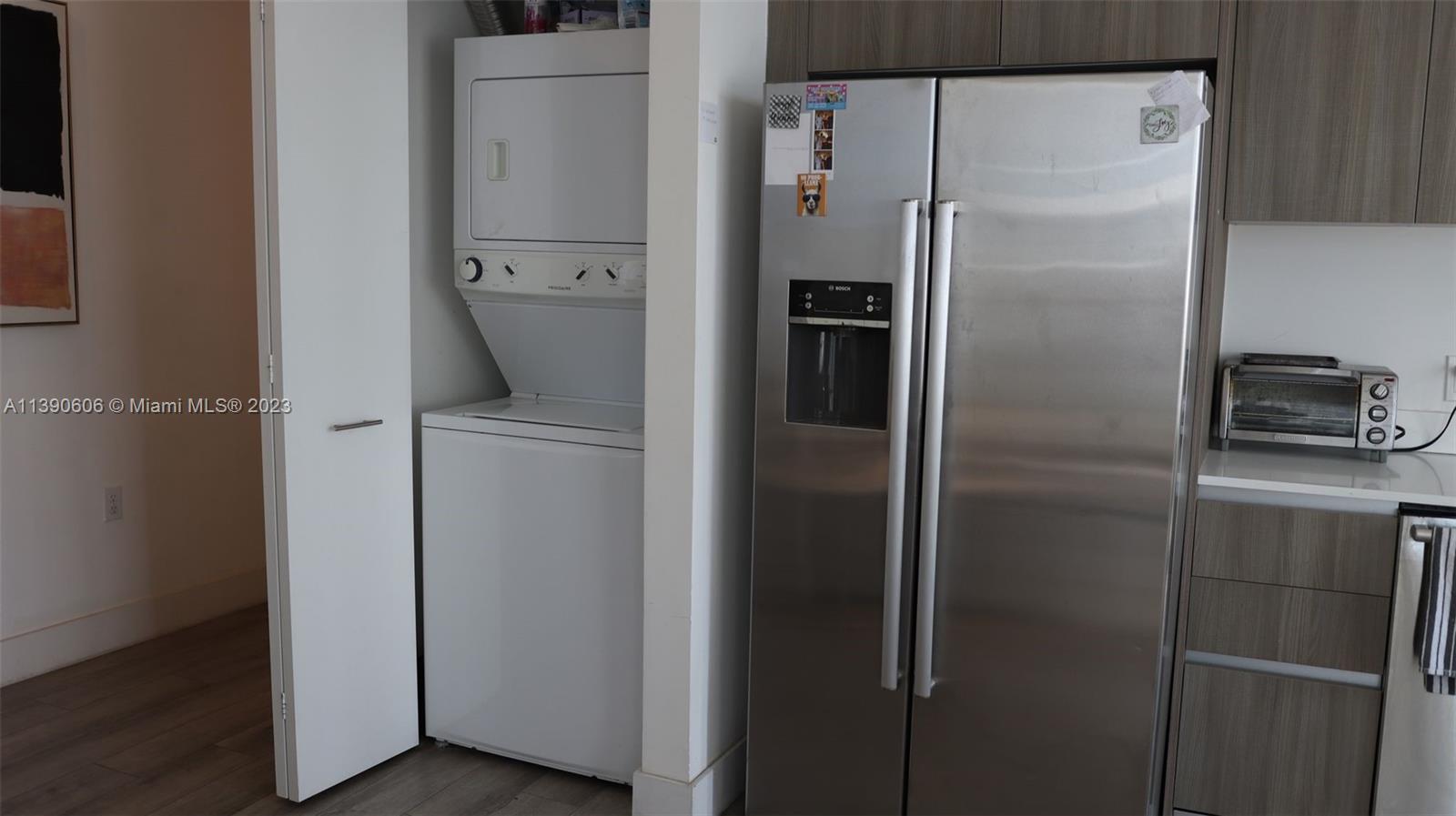 201 Southwest 17th Road, Unit 606 Miami, FL 33129 - Photo 2 of 37 a metallic refrigerator freezer sitting in a kitchen