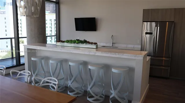 a kitchen with a sink and a refrigerator