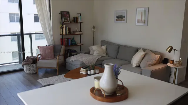 a living room with furniture and a book shelf