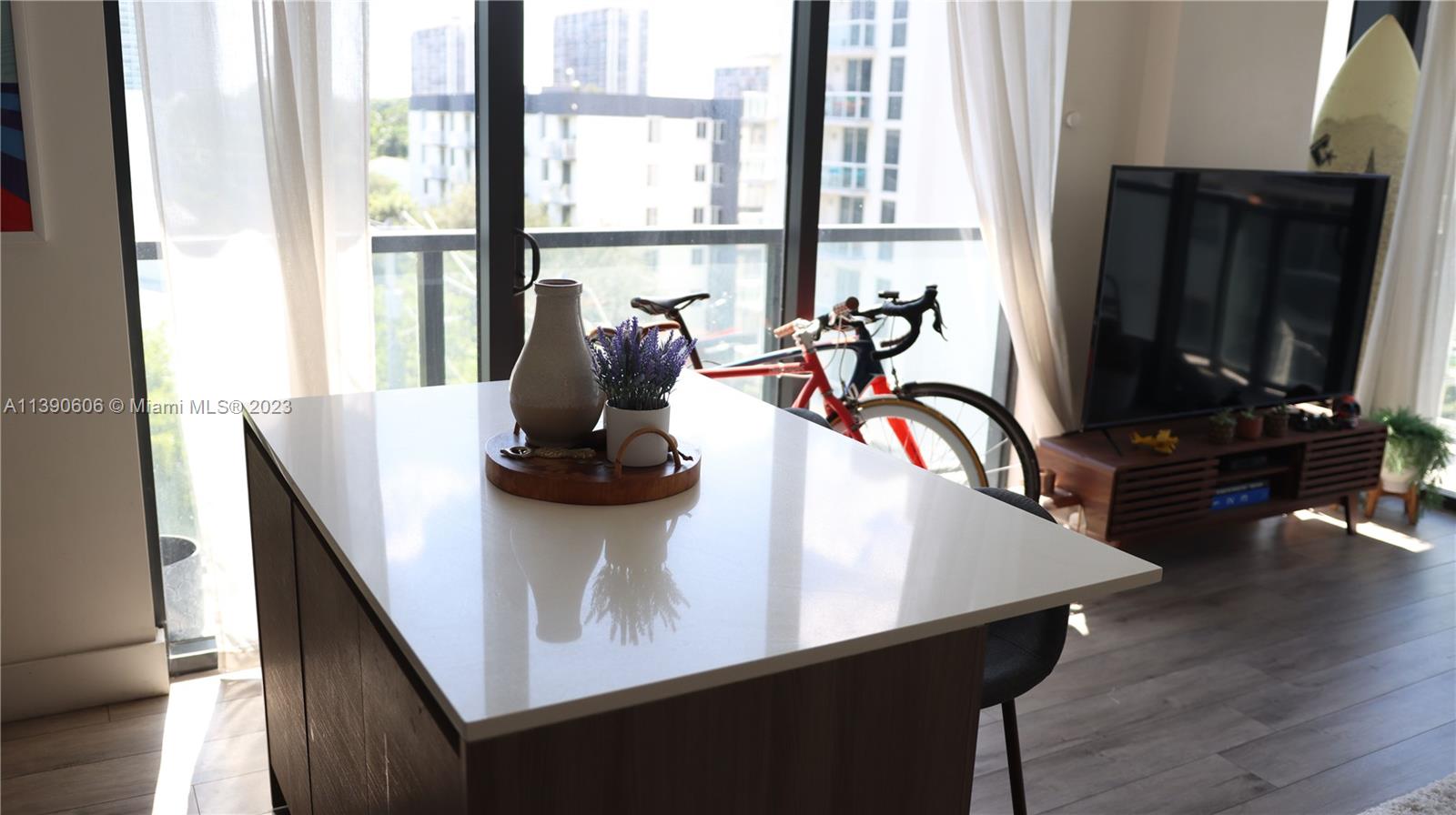 201 Southwest 17th Road, Unit 606 Miami, FL 33129 - Photo 5 of 37 a view of a dining room with furniture window and wooden floor
