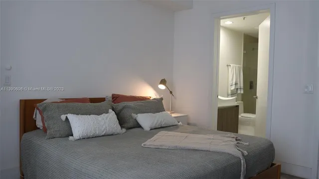 a bed room with a bed and a night stand